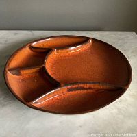 Full top view of the MCM style divided serving tray with four compartments and a warm orange-brown crackle glaze.