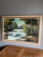 Front view showing the full painting and frame hung on wall.