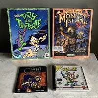 All four game boxes and jewel case laid out