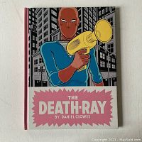Front cover of The Death Ray graphic novel by Daniel Clowes showing stylized superhero with ray gun and city background.