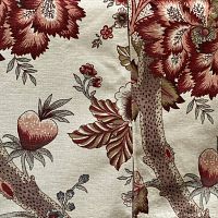 Closeup of the fabric showing detailed Tree of Life floral pattern in cream and red tones.