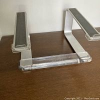 Front view of aluminum and plexiglas Griffin laptop stand showing the logo and rubber grip strips on the arms.