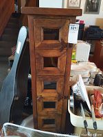 Full side view of the shelving unit showing the wood finish, door design with glass panels, and overall structure.