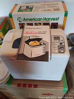 Sunbeam Expressbake Bread Maker on top of American Harvest Snackmaster box with instruction manual on top