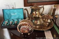 Full view of Marlboro EP Brass silver-plated tea set and tray, WM A Rogers silver-plated mini wine glasses in box, and shell-shaped napkin holder.