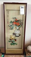 Framed Asian pop-out art with 3D floral and lion elements and calligraphy on beige background, upright view