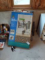 Photo of Top Paw pet gate box showing extra tall metal gate with walk-through door and pet images.