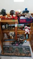 Wide view of the collection showing all items on shelves and tables including faux florals, candles, fabric mats, and assorted décor.