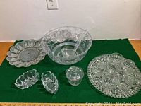 Full view of entire glassware set including punch bowl, deviled egg platter, silverware holders, candy dish, punch cups on tray, and ladle