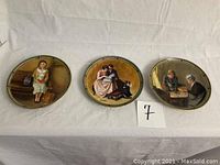 Three decorative Norman Rockwell collectors plates displayed on white surface, each with distinct vintage scenes.