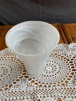 Top-down view of the white glass vase showcasing the flared rim and swirling internal pattern.