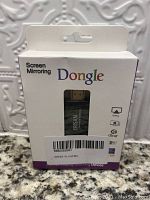 Front of packaging showing the screen mirroring dongle visible through a window with ERSAN branding. Box text includes 'Screen Mirroring Dongle', and icons for AirPlay, DLNA, and Miracast compatibility.
