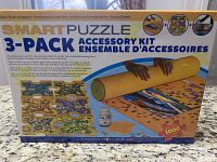 Box front showing product name and kit contents: puzzle mat, sorting trays, puzzle glue.