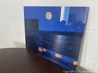 Contemporary barn scene artwork on metal panel showing moon at night and lights at bottom edge.