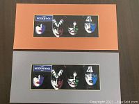 Two matted images of the Kiss band members showcasing their signature makeup, available in orange and grey matting.