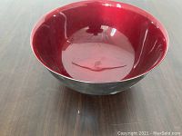 Top view of the metal bowl showing glossy red interior
