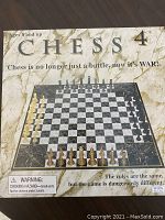 Front of the Chess 4 box showing the game name, tagline, age recommendation, and an image of the board with four color sets of pieces laid out.