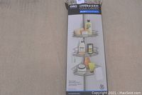 Photo of ORG Oversized Pole Caddy packaging showing the rust resistant feature and three adjustable shelves with toiletries.