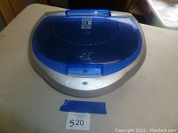 Top view of blue George Foreman Lean Mean Fat Grilling Machine with closed lid and bun warmer attachment.