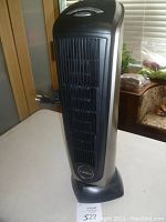 Front view of Lasko tower heater showing black vertical grille and Lasko logo at bottom center.
