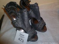 Front angle view of both gray studded wedge heels showing studs and overall shape.