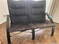 Front view of black collapsible loveseat with metal frame and fabric seating.