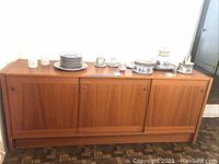 Front view of teak buffet with three sliding doors