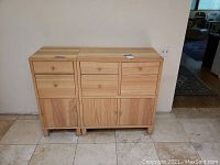 Wooden cabinet with three drawers at top and three cabinet doors below. Light natural wood tone with simple design.