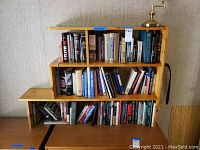 Bookshelves filled with a variety of books, mostly about sociology and related topics including Freud, arranged on a wooden bookshelf.