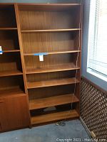 Full front view of the open bookshelf next to adjacent unit.