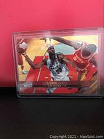 LeBron James 3rd year card displayed in a plastic case against a red background, showing action shot of LeBron James in Cavaliers uniform.