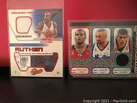 Photo showing two basketball insert cards; the first card has two fabric patches from a game-worn jersey and a picture of Grant Hill in Orlando Magic attire; the second card is an autographed tri-player card with a green fabric swatch