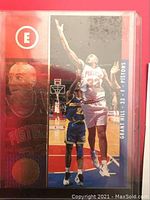 Close-up image of the Grant Hill rookie basketball card featuring a holographic finish and large 'E' logo.