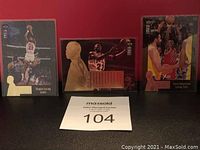 Three Michael Jordan basketball insert cards displayed against red background