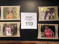 Four Upper Deck Predictor basketball cards featuring Michael Jordan (Bulls), Shaquille O'Neal (Lakers), Allen Iverson (76ers), and Kevin Garnett (Timberwolves) displayed on black surface.