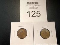 Two Canadian Tombac nickel coins in protective holders, dated 1942 and 1943, showing obverse and reverse sides.