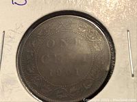 Reverse side showing ONE CENT 1901 with decorative vine pattern