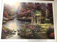 Frontal photo of the lithograph showing full artwork including the stone gazebo, river, and colorful garden foliage.