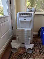 Front view of unit with window panel and hose adapters laid in front