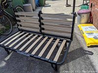 Ikea futon frame in couch position showing metal frame and wooden slats