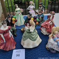 All nine figurines arranged on blue cloth showing entire lot