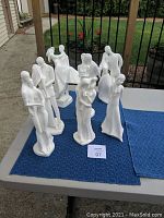 Overview of six white porcelain figurines on table