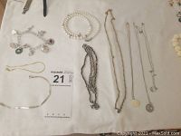 Overview of bracelets and necklaces laid out on white background