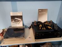 Photo showing Technics SL-5 turntable with manual and Yamaha RX-V540 receiver with remote and cables on top