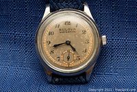 Close-up of watch dial showing Bulova Watertite logo, Arabic numerals, subsidiary seconds and patina