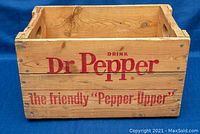 Front view of the wooden crate featuring the text 'Drink Dr Pepper' and 'the friendly "Pepper Upper"' in red.