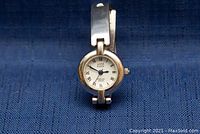 Close-up of the Anne Klein watch face with Roman numerals and silver bezel.