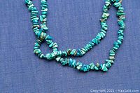 Close-up image of turquoise nugget necklace beads showing color, texture, and bead shapes.