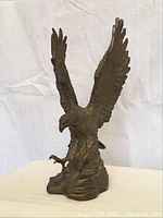 Front view of brass eagle sculpture showing full figure