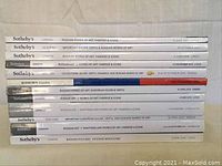 Photo of the side spines of 12 Sotheby's Russian art auction catalogues showing titles and dates from 2003 to 2017.